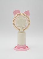 Pink handheld fan with cat ears on a light gray background